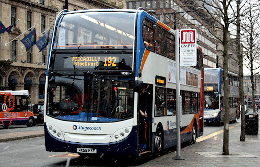 a double decker bus travelling from Picccadilly to Stockport on a cloudy autumn morning