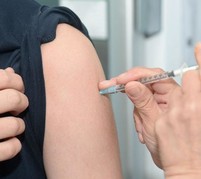 a vaccine being put into an arm