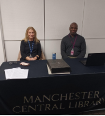 photo of two people sitting down at a stall