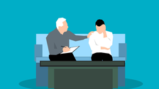 a cartoon of a counselling session. One man is listening closely to another and offering a comforting pat on the shoulder. 