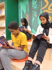 Children with books inside library