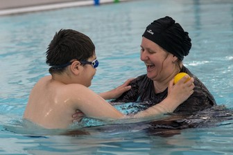 Mother and son having fun in pool