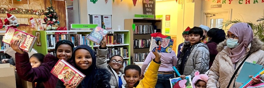 kids holding christmas books
