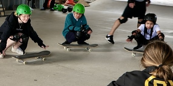 Young people learning skateboarding