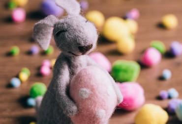 Toy Easter Bunny holding Easter eggs