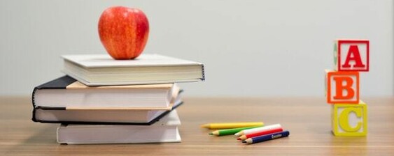 School books, apple and ABC blocks