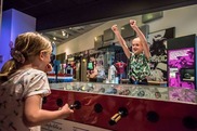 Two children playing a tabletop football game