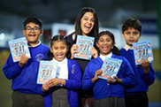 Author Rashmi Sirdishpande with four school children all holding her book 'We've Got This'
