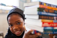 Afidat smiling with books