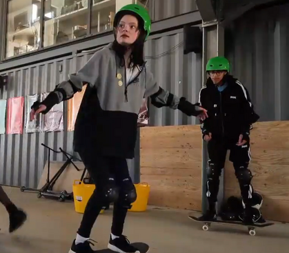 Two young people skate-boarding