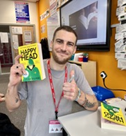 YA author Josh Silver pictured holding his book, Happy Head