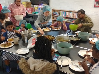 Families eating meal they have cooked together