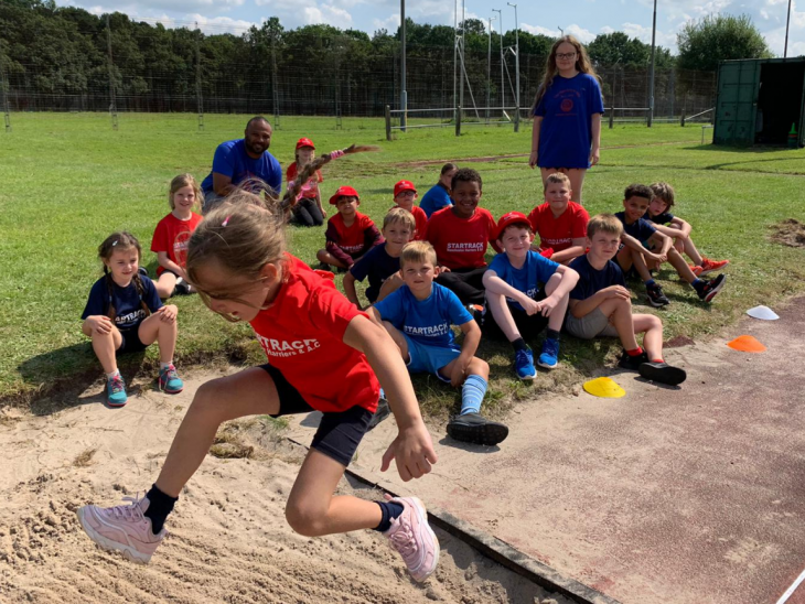 Children attempting the long jump