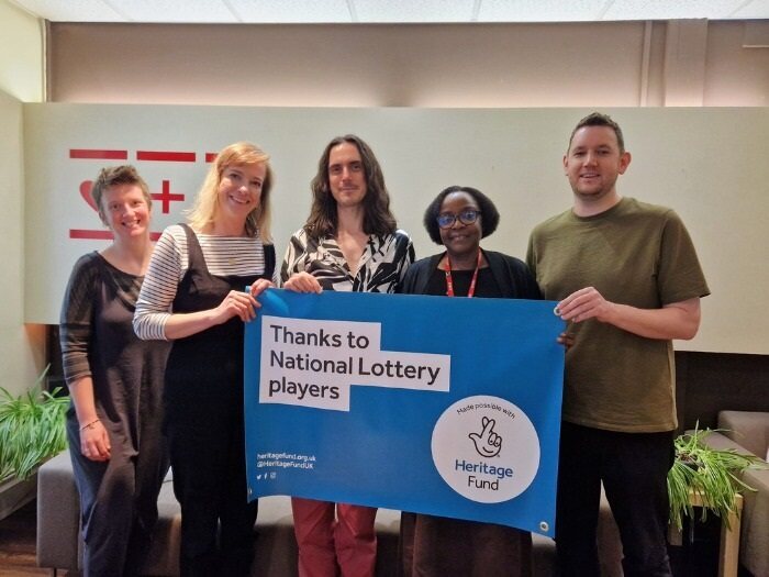 Staff holding a Lottery Fund banner
