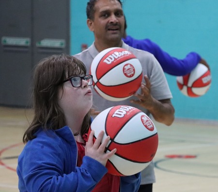 Learning disabled girl being coached in netball