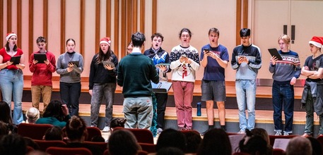 Young people singing Christmas carols on stage