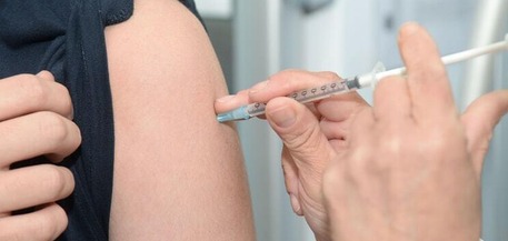 Woman getting vaccine in her arm