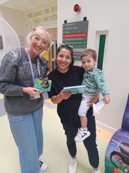 Mum  and son receiving their Little Moments Together cards from NLT Early Years Programme Mananger