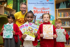 Children taking part in the Summer Reading Challenge 2024, holding their drawings.