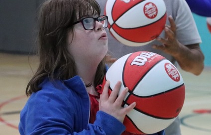 Learning disabled girl being coached in netball