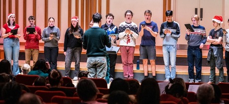 Line of people singing on stage