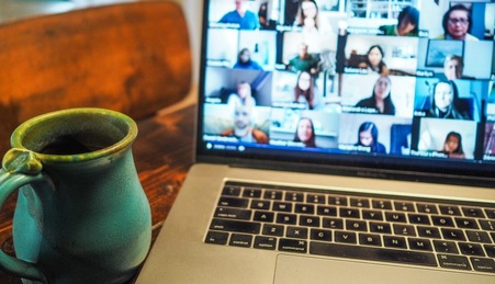 Cup of coffee in front of computer Zoom call