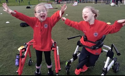 Two happy young footballers with cerebral palsy