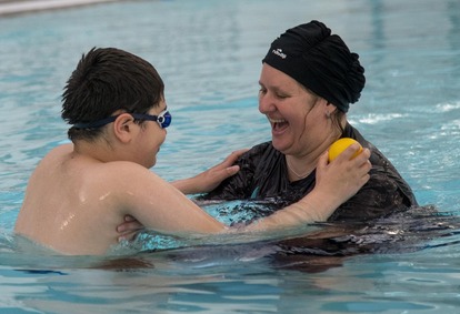 Mother and son swimming together