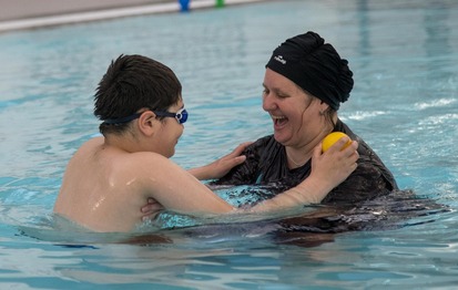 Mother and son swimming