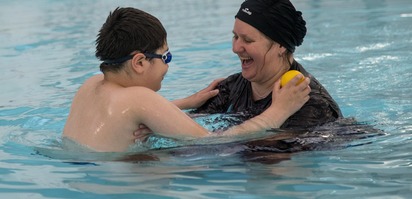 Mother and child swimming together
