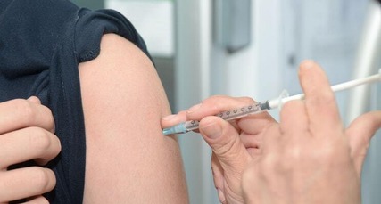 Person having an injection in their arm