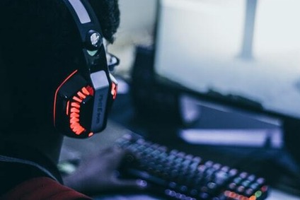 Young person in headphones at a computer