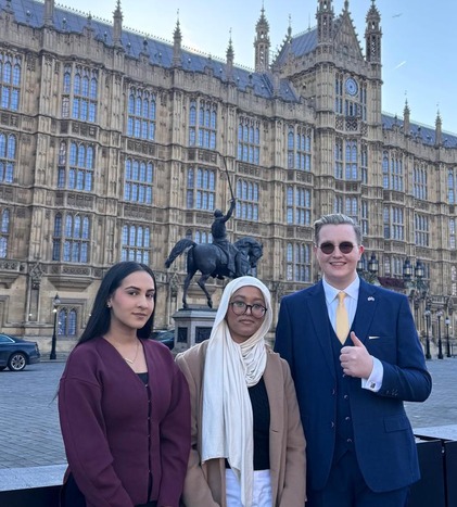 Three members of Youth Parliament standing outside Westminster