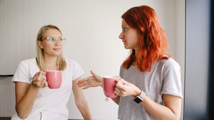 Two women talking over a coffee