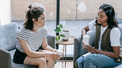 Two women talking over a coffee