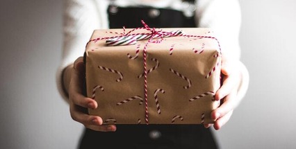Girl holding out parcel