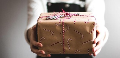 Girl holding out parcel