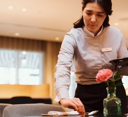 Young woman training as a waitress