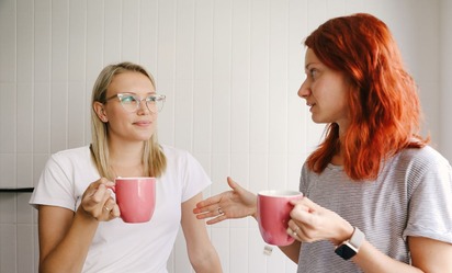 Two women talking over a coffee