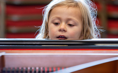 Child looking at piano