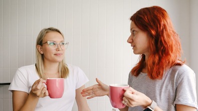 Two women talking over a brew