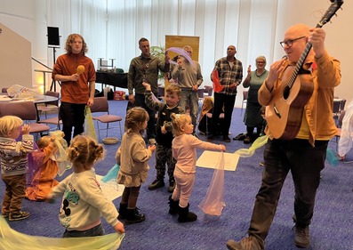 Adults and children being creative together