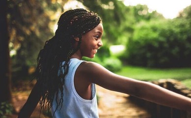 Girl smiling in a park in the summer