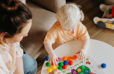 Woman watching child play