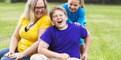 Boy sitting on grass with his family