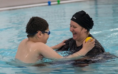Mother and child swimming together