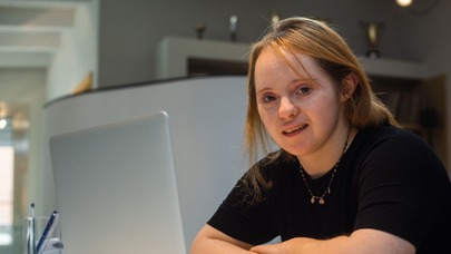 Young woman with Downs Syndrome at a computer