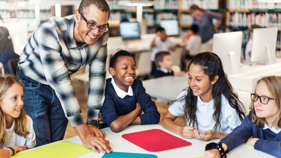 Smiling teacher with a group of pupils