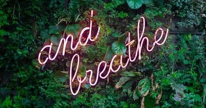 'And breathe' lighted sign