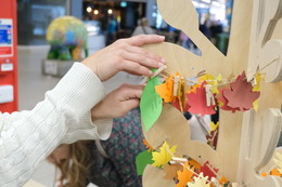 Person adding a promise to Maidstones Promise tree